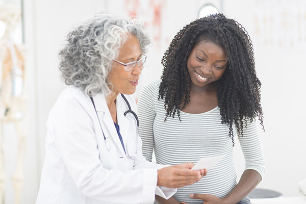Pregnant woman talking to doctor