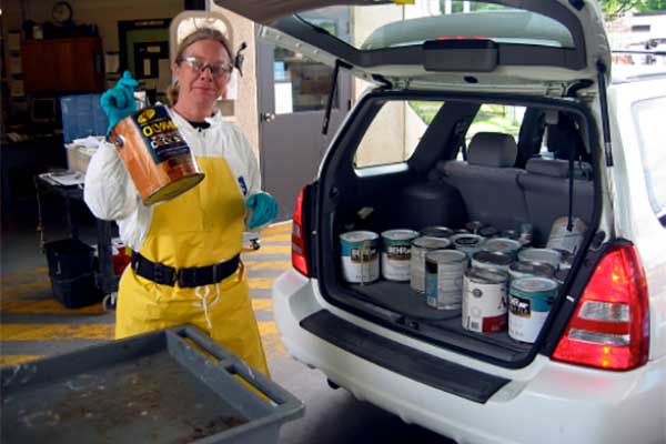Unloading paint cans from a car