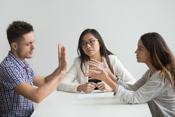 A couple having a dispute mediated by a counselor