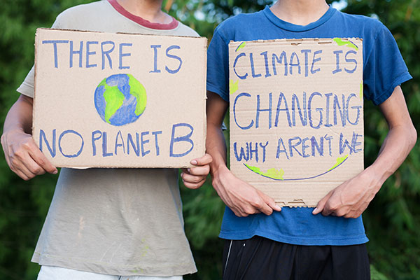 Students holding up climate change signs