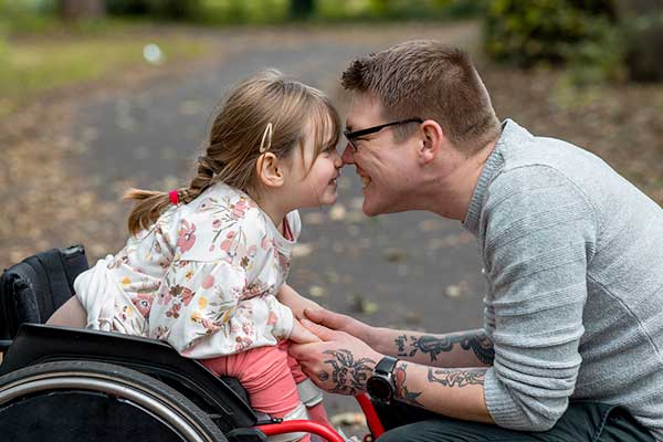 Father with young daughter in wheelchair