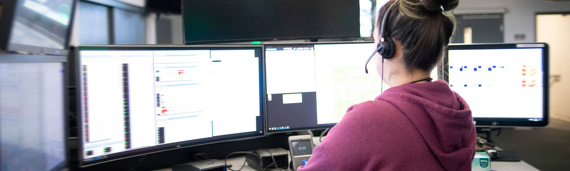 Nurse at a computer with headphones on