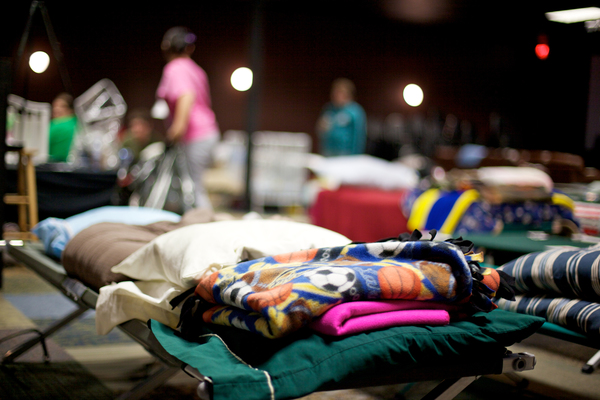 cots and blankets inside a shelter