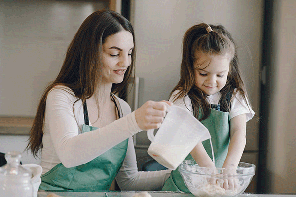 Mother and daughter cooking