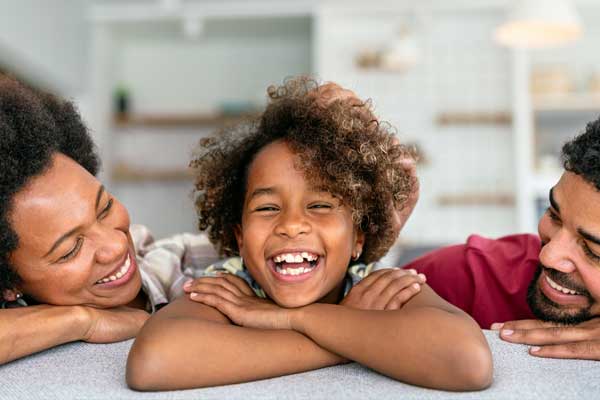 Young girl laughing with her family