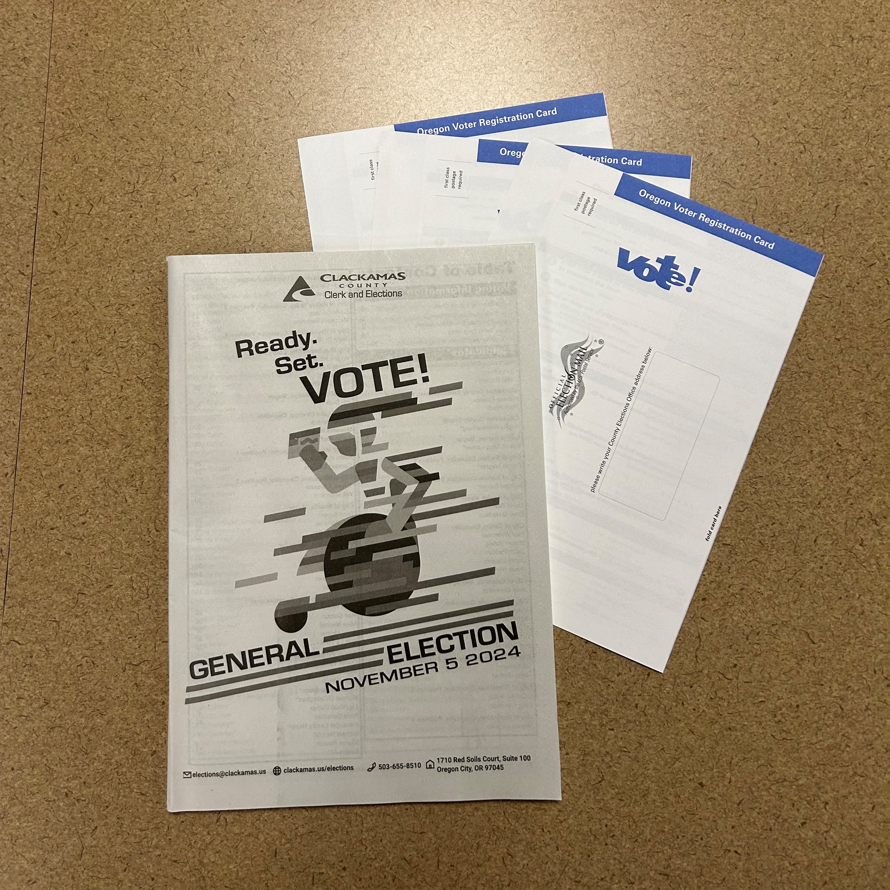 County Voters' Pamphlet and Voter Registration Cards on a counter