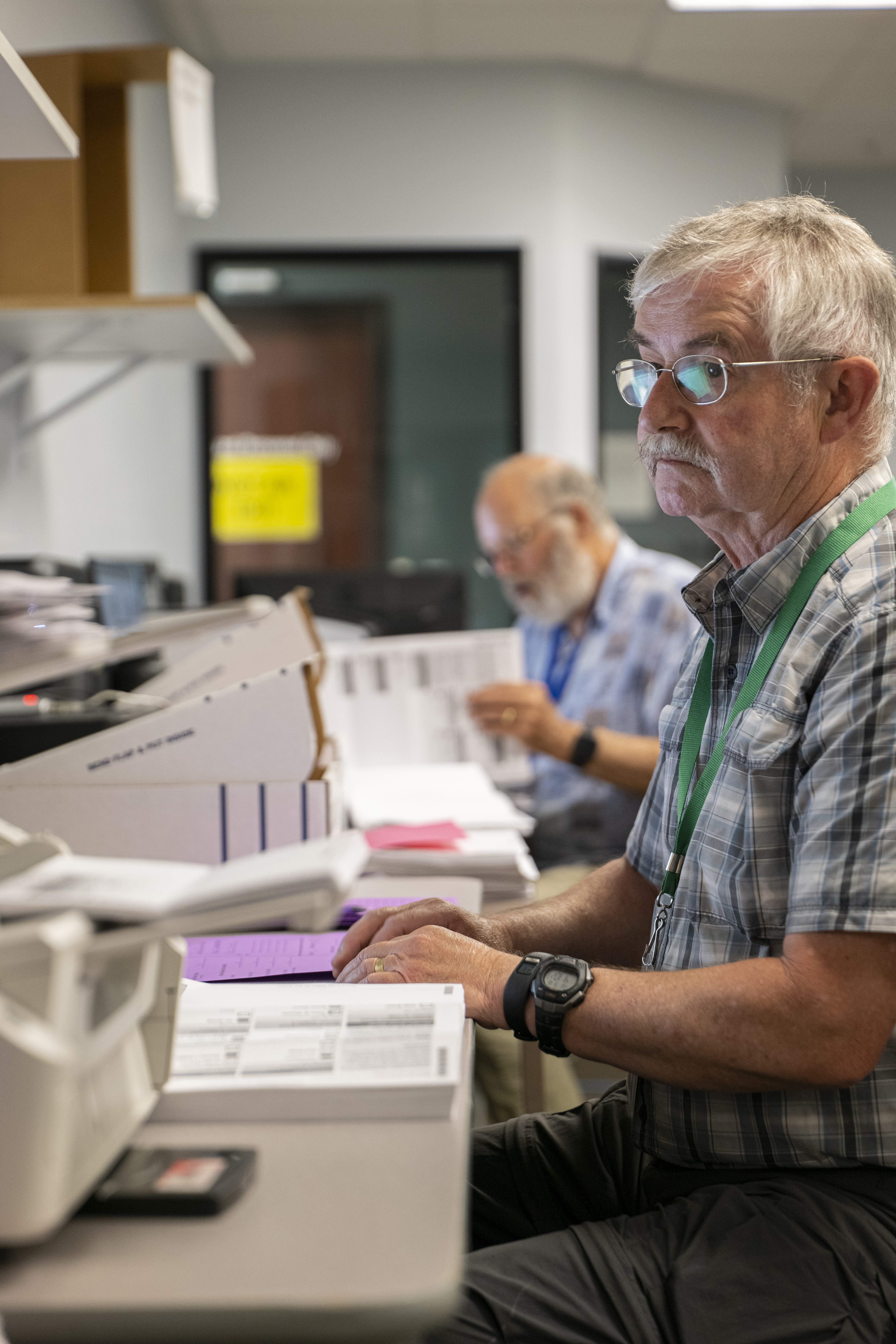 Election workers scan ballots on Election Night 