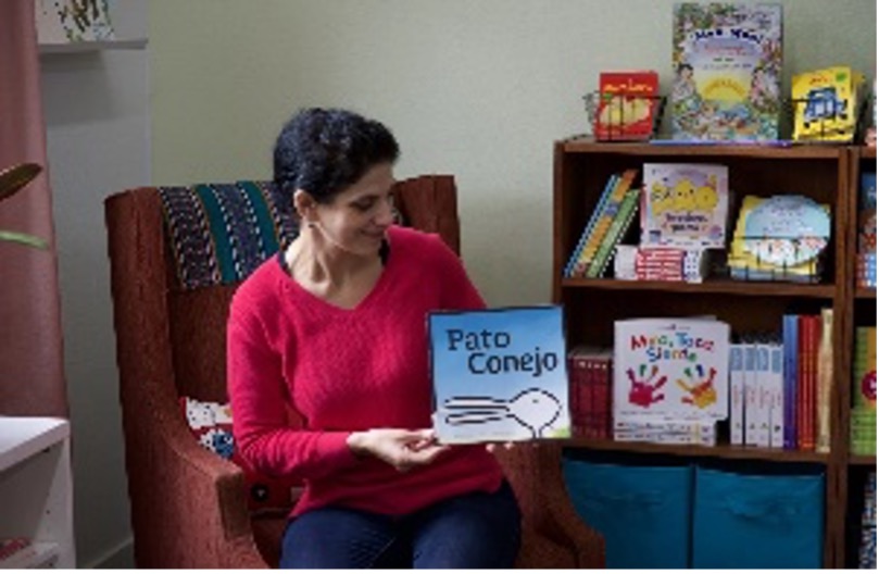 woman sitting in chair reading a book