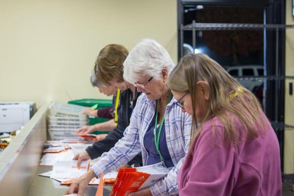 Election workers process ballots on election night.