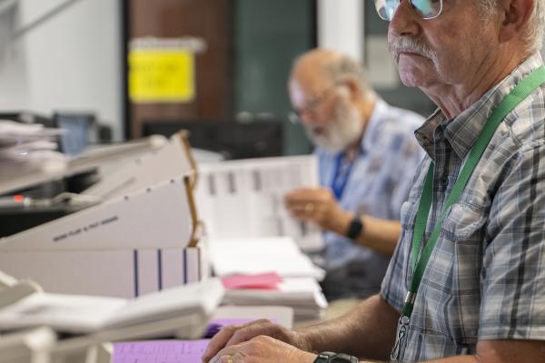 Election workers scan ballots on election night.