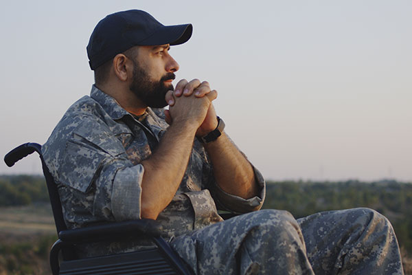 A veteran in a wheelchair watching a sunset